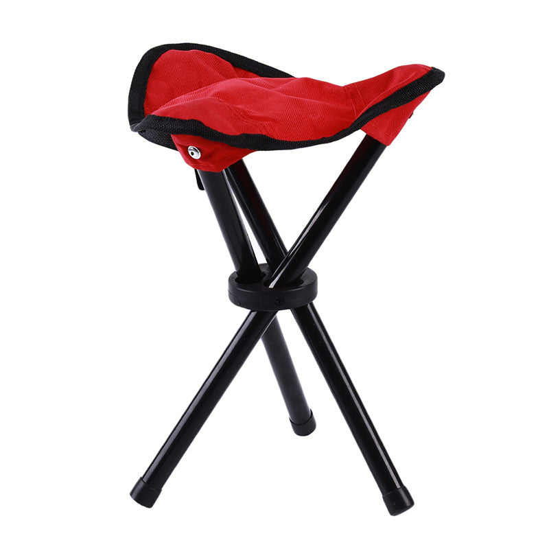 Red folding stool with black legs on a white background