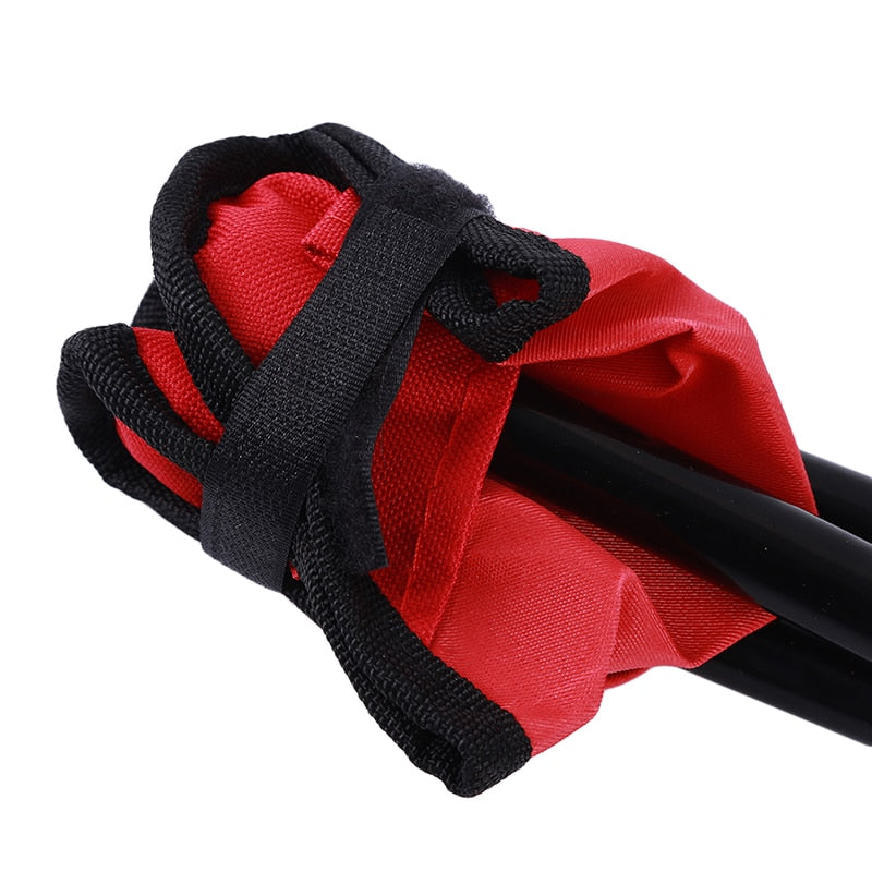 Close-up of red folding stool with black legs on a white background