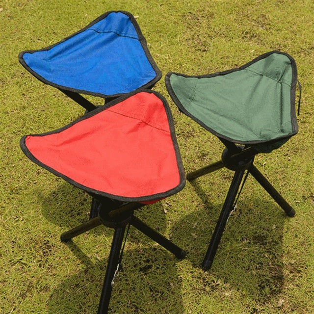 Three portable stools in blue, red, and green on grass